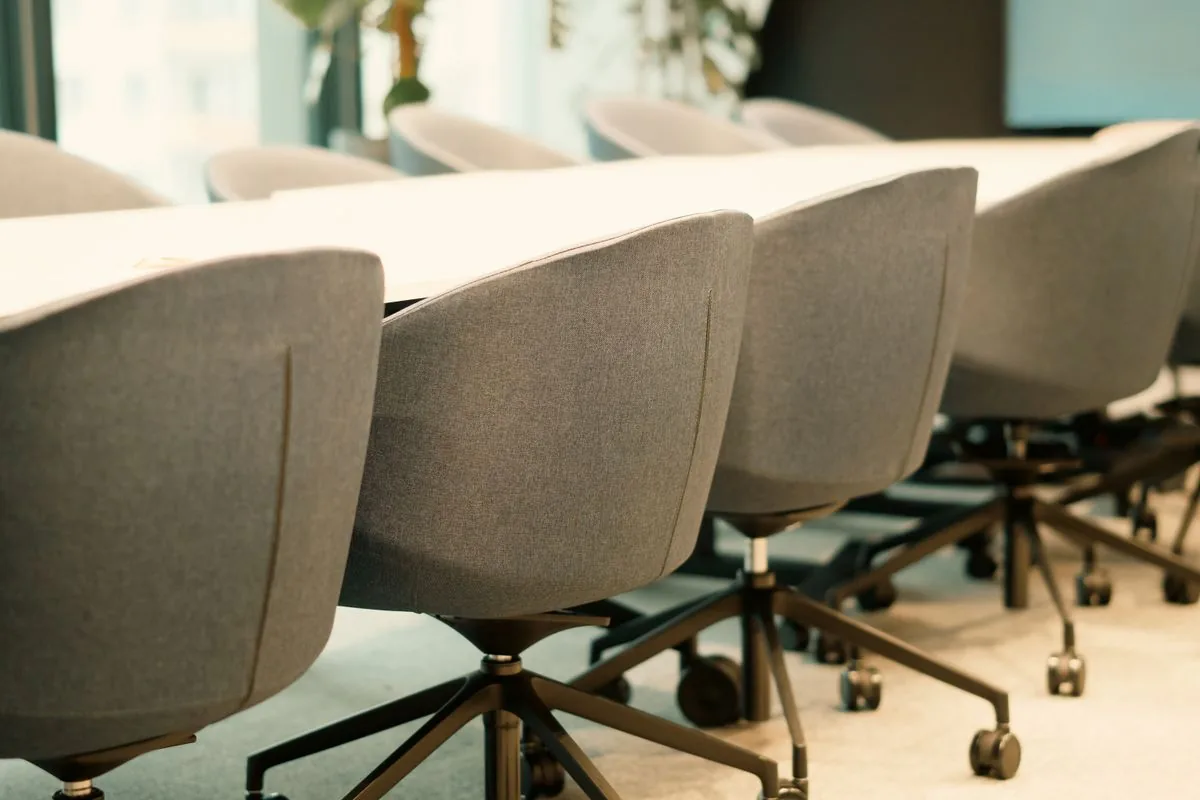Modern workplace meeting room with chairs around a conference table